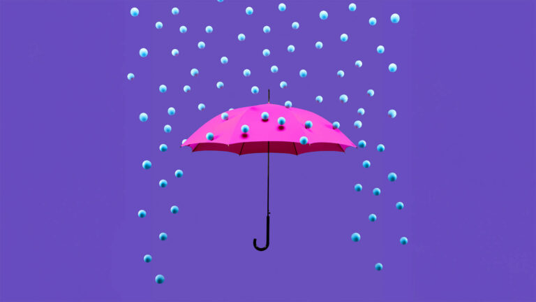 Blue pearl-like balls raining down on an open umbrella.